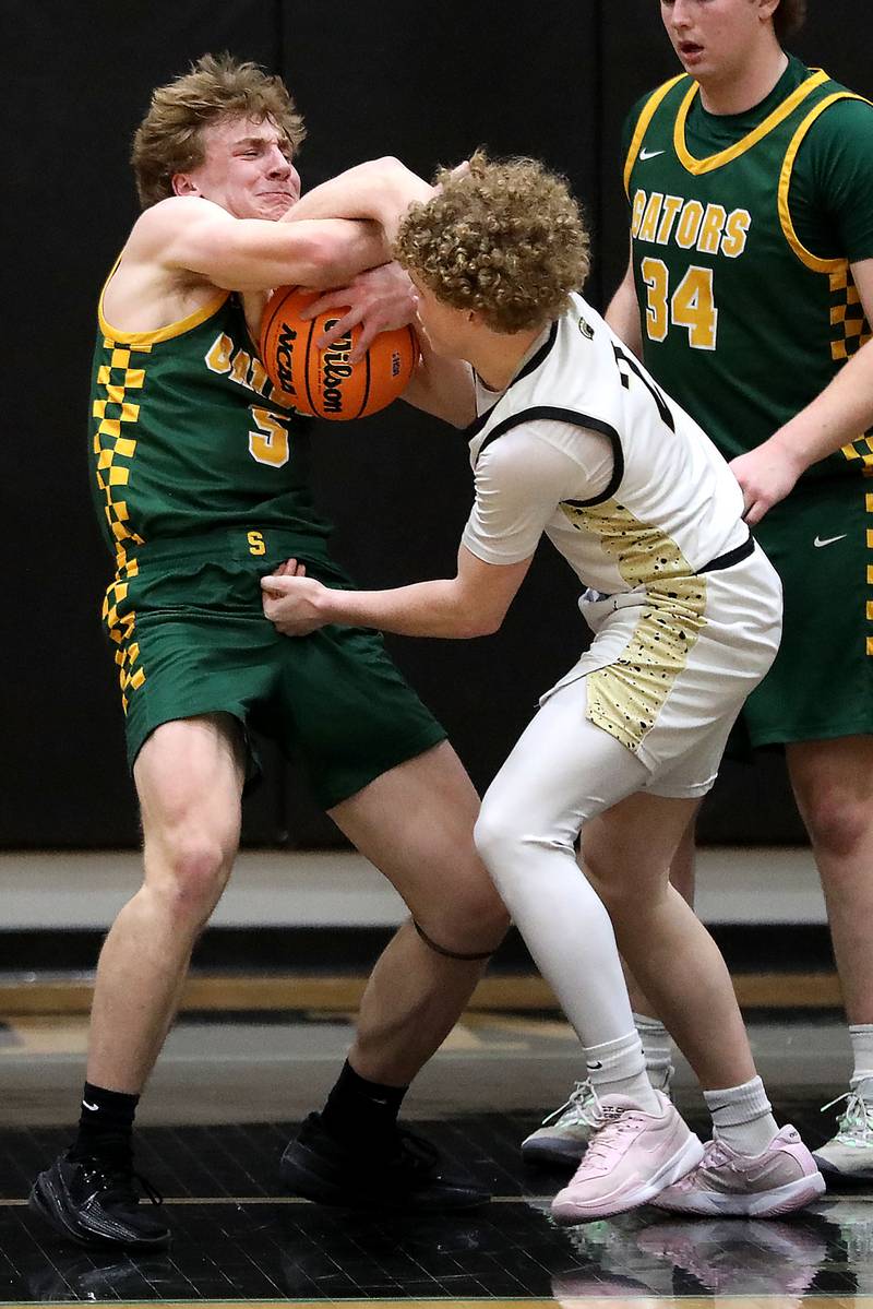 Crystal Lake South's Carson Trivellini battles with Sycamore's Logan Hodges for the ball during an IHSA Class 3A Woodstock North Sectional semifinal.basketball game on Wednesday, March 4, 2025, at Woodstock North High School.
