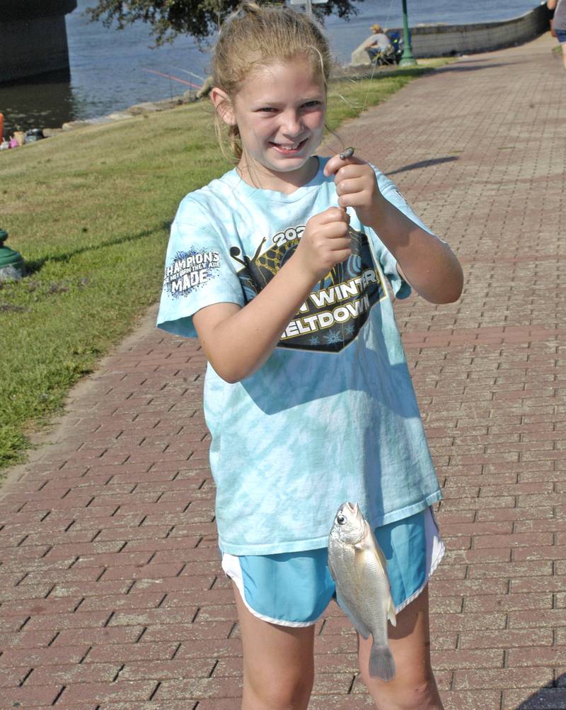 Allyson Wilson holds up a fish she caught Saturday, July 5, at the Elks Fishing Derby during Dixon's Petunia Festival.