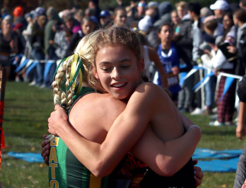 Crystal Lake Central’s Hadley Ferrero is congratulated after a Class 2A Sectional Cross Country Meet at Emricson Park in Woodstock Saturday.