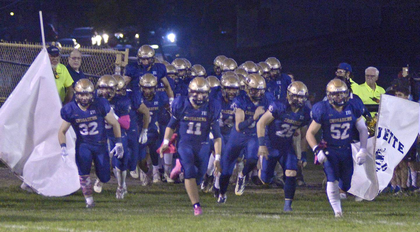 The Marquette Crusaders take to the field prior to the start of Friday night’s game against Seneca at Marquette.