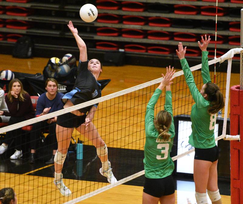 Willowbrook's Calli Kennyy (9) hits into the York blockers during Monday's Proviso West Class 4A girls sectional volleyball match in Hillside.