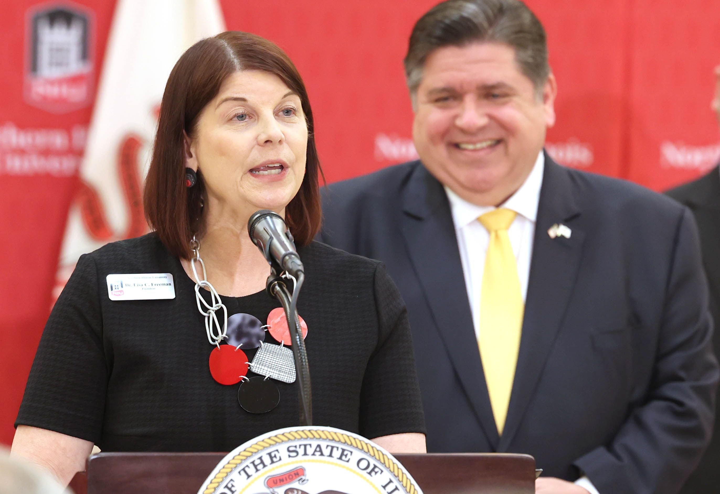 Northern Illinois University President Lisa Freeman speaks as Gov. JB Pritzker looks on during a news conference Tuesday, April, 4, 2023, in the Barsema Alumni and Visitors Center at Northern Illinois University in DeKalb. Pritzker along with a group of llinois lawmakers, DeKalb city officials and representatives from NIU were on hand to promote the importance of funding higher education in Illinois.