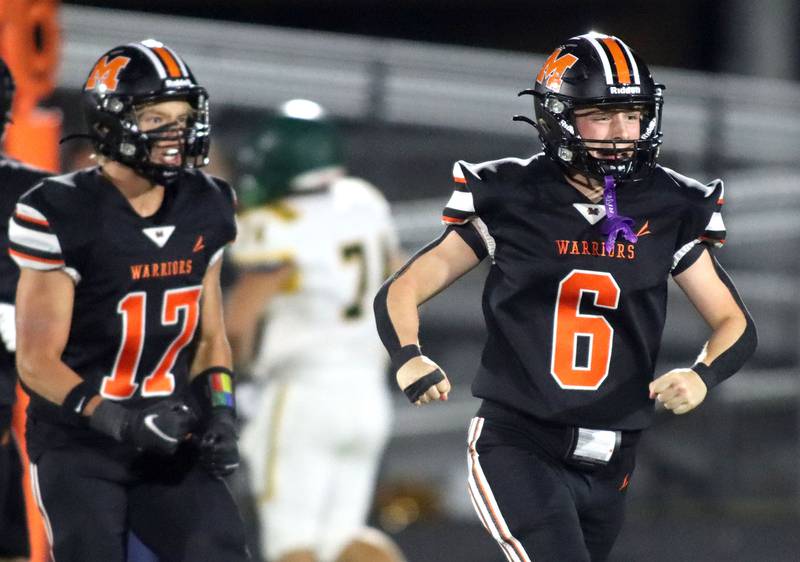 McHenry’s Lucas Decker, right, and Nolan Chovanec, left, celebrate a Decker interception against Crystal Lake South  in varsity boys football at McCracken Field on the campus of McHenry High School in McHenry on Friday, Sept. 5, 2025.