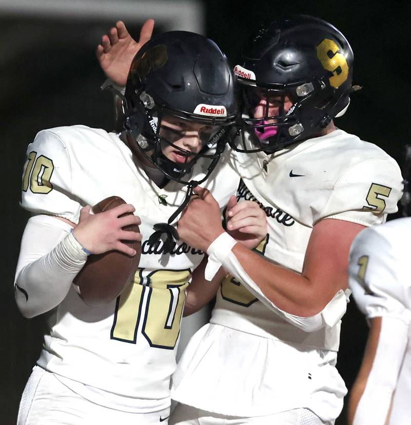 Sycamore's Burke Gautcher is congratulated by Sycamore's Kyle Prebil after scoring a touchdown during their game Friday, Oct. 20, 2023, at Morris High School.