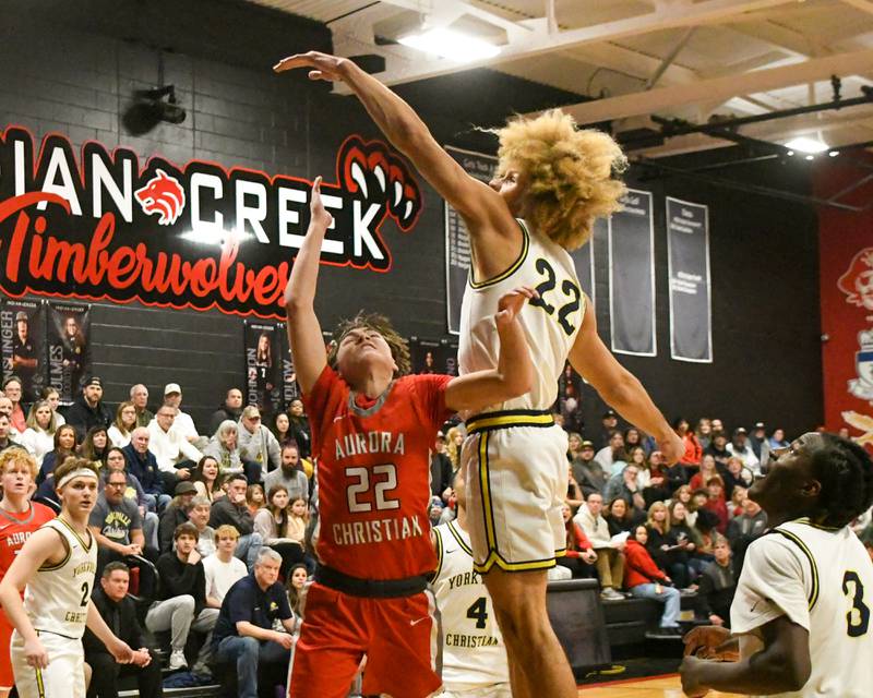 Aurora Christian's Jacob Baumann, left, makes a basket while being defended by Yorkville Christian's Noah Aguado (22) during the game on Friday Feb. 28, 2025, during the regional title game held at Indian Creek High School.