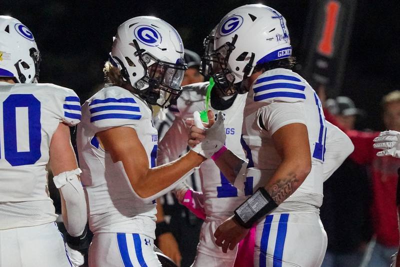 Geneva’s Finnegan Weppner (8) shakes hands with Anthony Chahino (12) after catching his third touchdown pass of the game during a football game against Batavia at Batavia High School on Friday, Oct. 4, 2024.