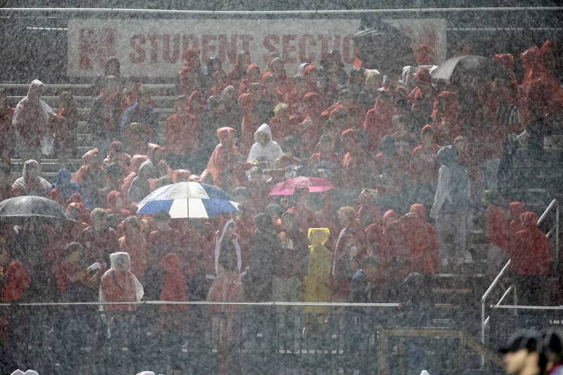 Pouring rain greets the Naperville Central and Downers Grove South players at the start of the game Friday October 27, 2023 in Naperville.