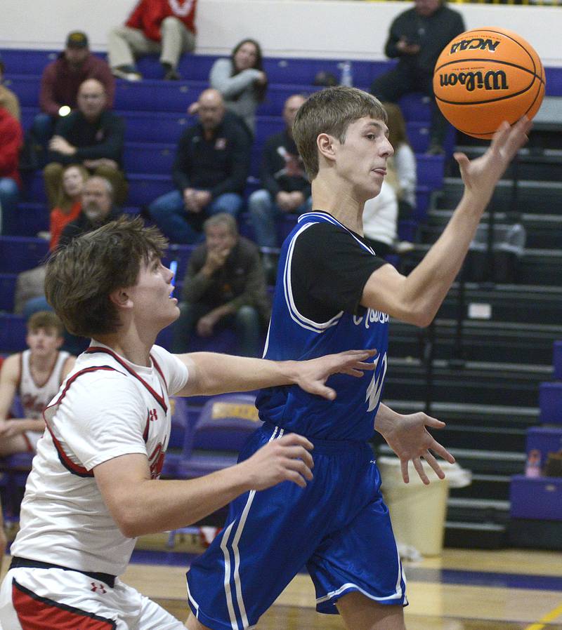Newark’s Dylan Kulbatz tries to flip the rebound away from Hall’s Greyson Bickett in the 1st period Tuesday at Serena.