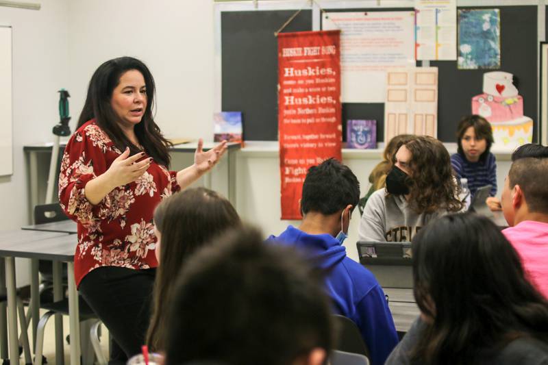 Glenbard South English teacher Linette Chaloka’s accentuates a point during a class. Chaloka encourages her students to see the world through the eyes of the characters in the novels they study. (Photo - Glenbard Township High School District 87)