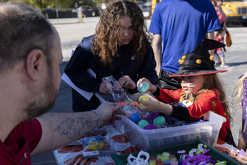 Raven Jade Meyer, 5, of Rock Falls picks out a prize from the prize bin after winning tickets Saturday, Oct. 22, 2022 at First Student transportation’s Halloween fest in Rock Falls.