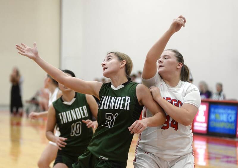 West Carroll's Emma Randecker (21) and Oregon's Madelyn Wendt (34) battle for a rebound at the Oregon Girls Basketball Tip-Off Tournament on Wednesday, Nov. 20, 2024 at the Blackhawk Center in Oregon.