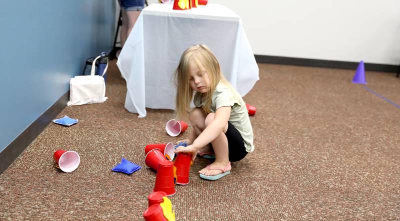 Genevieve Kieca, 3, of Darien plays a game inspired by the Marshall character during a Paw Patrol party at the Indian Prairie Public Library in Darien on Friday, June 28, 2024.