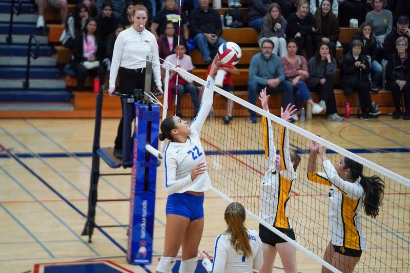 St. Charles North's Sidney Wright (22) plays the ball at the net against Metea Valley during a Class 4A West Aurora Sectional semifinal volleyball match at West Aurora High School on Tuesday, Nov. 5, 2024.