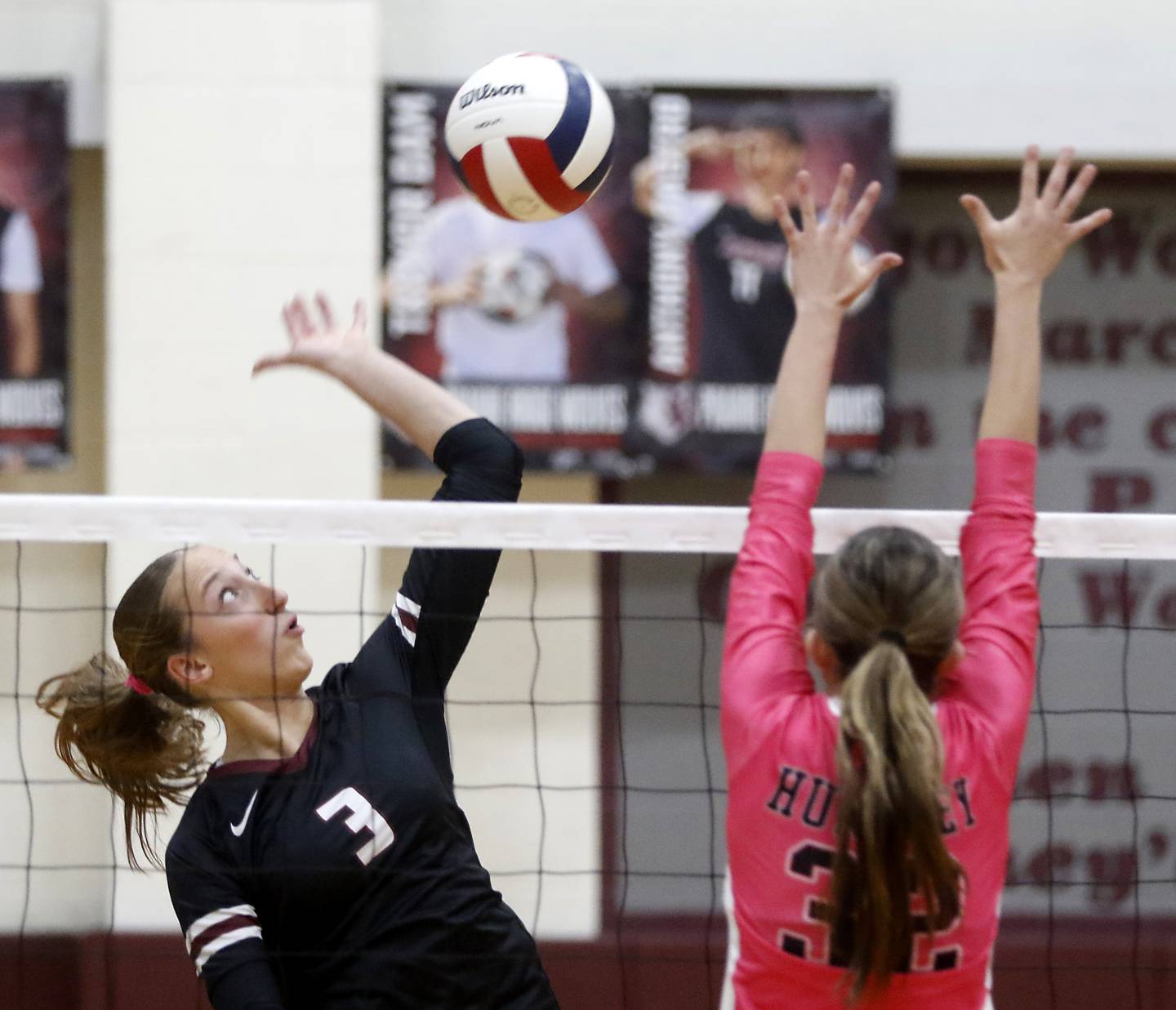 Prairie Ridge's Abby Smith hits the ball as Huntley's Izzy Whitehouse tries to block during a Fox Valley Conference volleyball match on Tuesday, Oct. 14, 2025, at the Prairie Ridge High School in Crystal Lake.