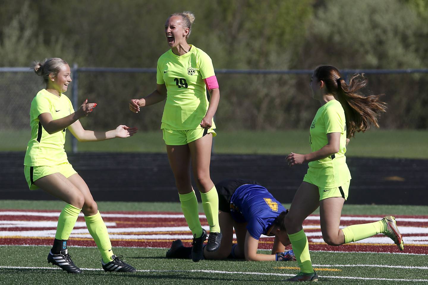 Richmond-Burton's Layne Frericks (center) celebrates her goal with teammates, Jordan Otto (left) and Nicole Mendlik, during the Kishwaukee River Conference Girls Soccer Tournament Championship Match against Johnsburg on Wednesday, May 1, 2024, at Richmond-Burton High School.