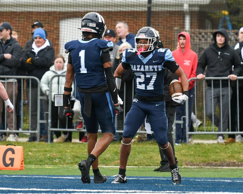 Nazareth Academy's Charles Calhoun (27) celebrates his touchdown with teammate Trenton Walker (1) during the 6A semifinals game on Saturday Nov. 22, 2025, held at Nazareth Academy High School in La Grange Park.