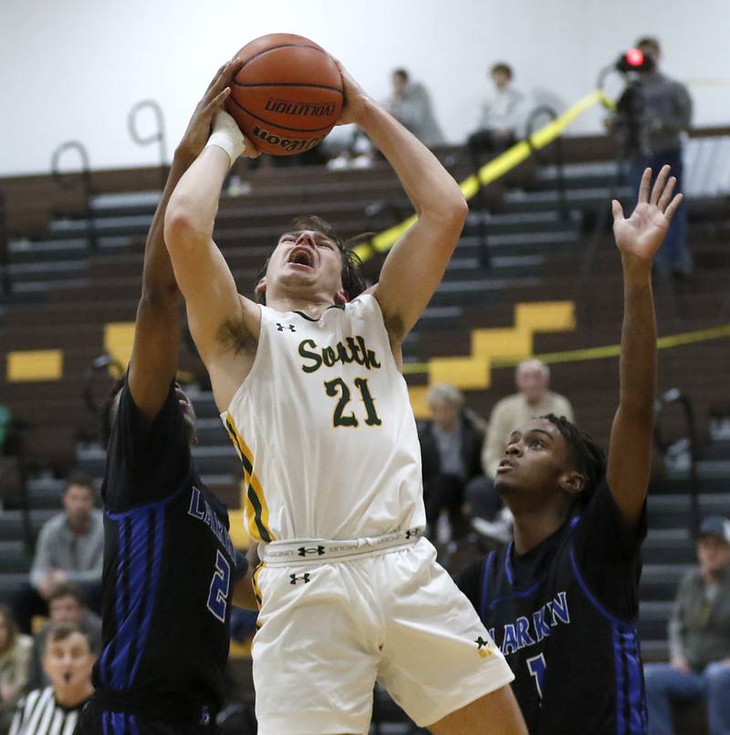 Crystal Lake South's Cooper LePage drives to the basket against Larkin’s Jasavion Sowers and Joshua Hibbett during a Hinkle Holiday Classic basketball game Wednesday, Dec. 28, 2022, at Jacobs High School in Algonquin.