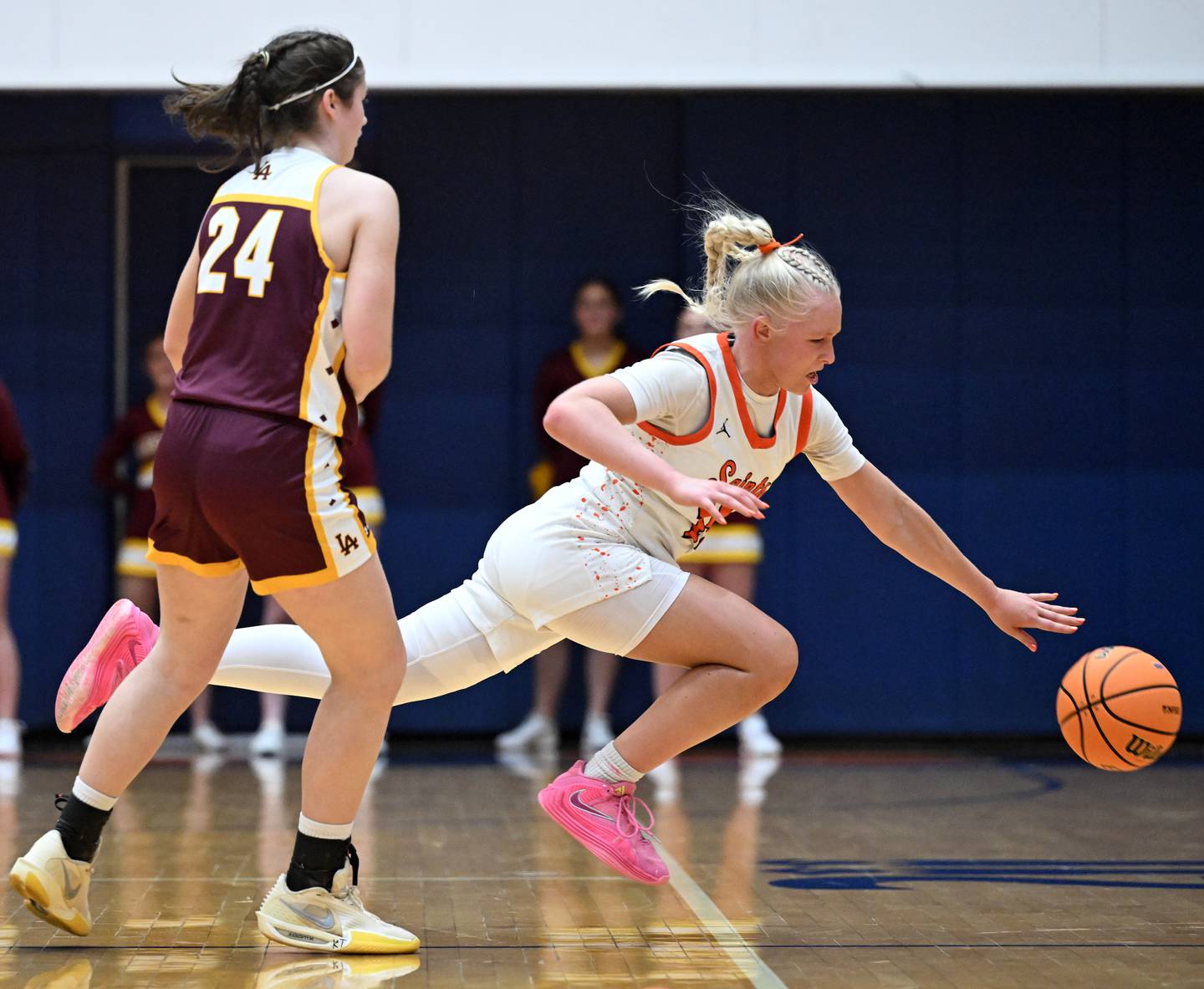 St. Charles East's Addie Schilb, right, chases a loose ball ahead of Loyola Academy's Michaela Burm during the Class 4A girls basketball supersectional at Hoffman Estates High School on Monday, March 2, 2026.