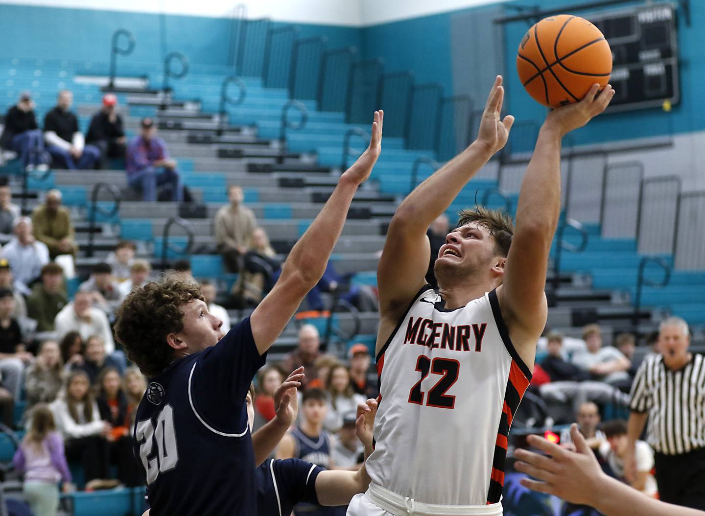 McHenry's Conner McLean shoots the ball over Cary-Grove's Ryan Boutwell during the Woodstock Hoops for Healing Tournament Championship game on Wednesday, Nov. 27, 2024, at Woodstock North High School.
