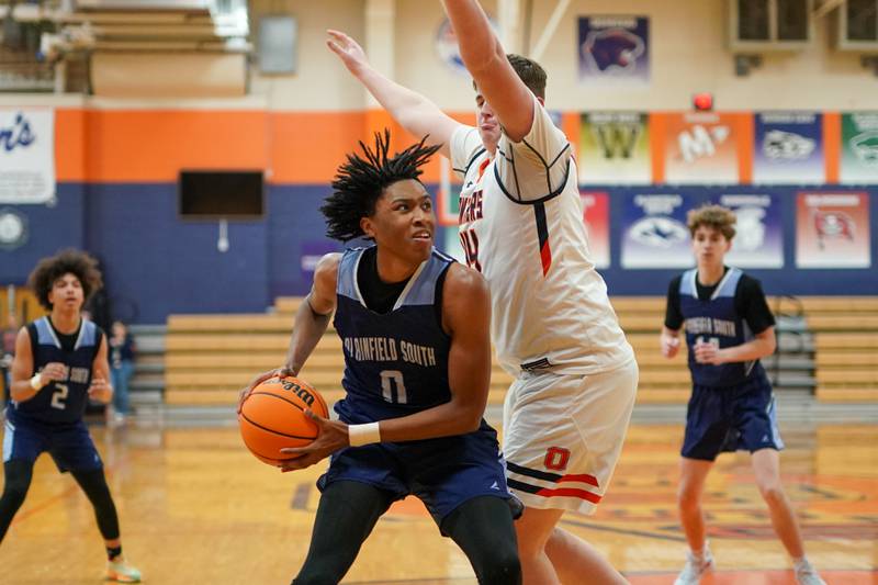 Plainfield South's Kareem Parker (0) plays the ball in the post against Oswego’s Hunter O’Neill (44) during a basketball game at Oswego High School on Friday, January 17, 2025.