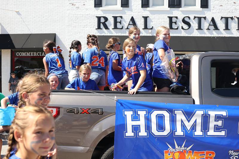 Members of the New Lenox Softball league show of they arm strength throwing out candy to the crowds in the Manhattan Labor Day Parade on Monday, Sept. 4, 2023 in Manhattan.