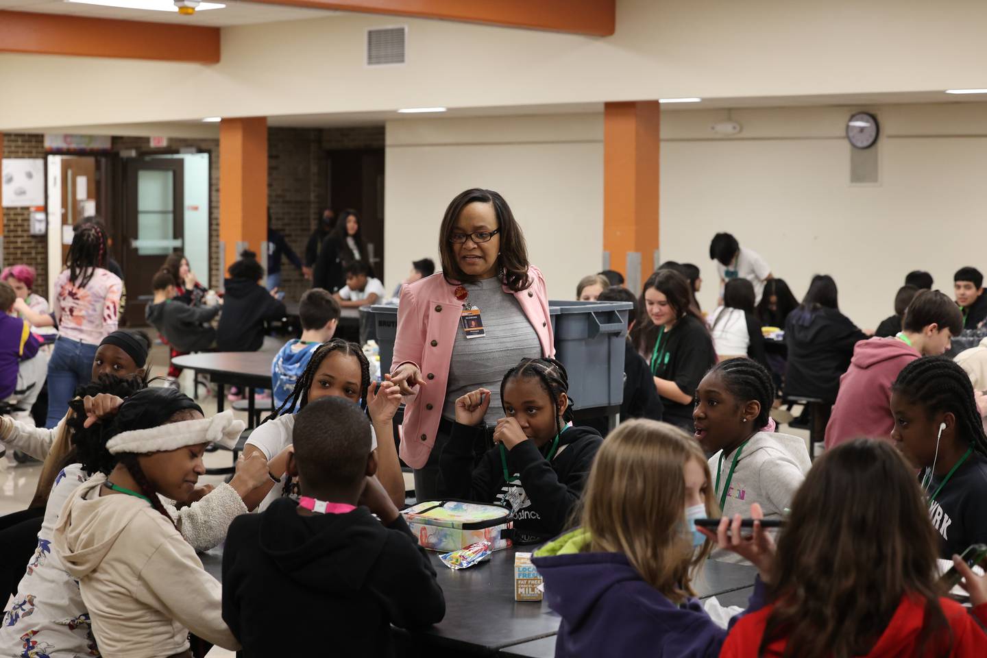 Treveda Redmond, principal at Huntley Middle School, talks with sixth-grade students during lunch Tuesday, March 14, 2023, at the school in DeKalb.