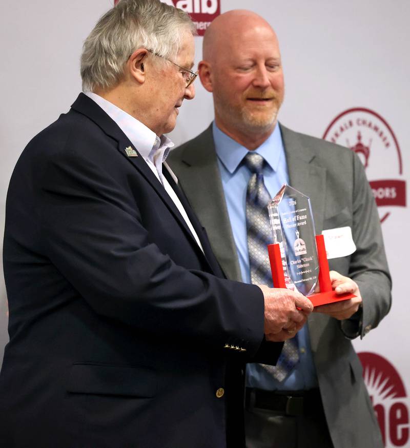 Jerry Smith (left) accepts the Hall of Fame Pioneer award on behalf of Chuck Siebrasse and family from DeKalb Chamber of Commerce board chair Shawn Lowe Thursday, Feb. 5, 2026, during the DeKalb Chamber of Commerce Annual Celebration Dinner at Faranda's Banquet & Conference Center.