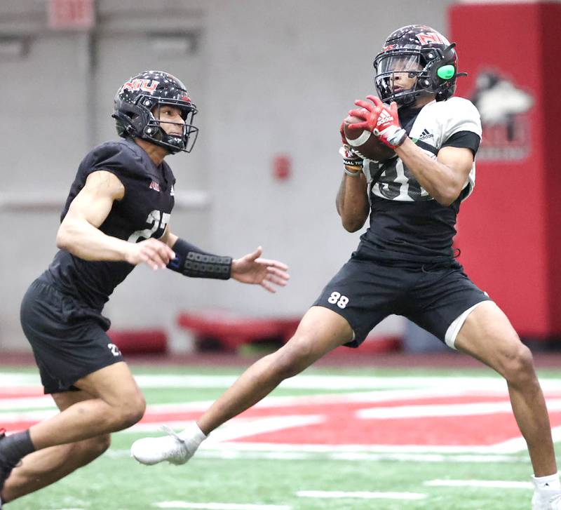 Northern Illinois receiver Malik Armstrong catches a pass behind safety Trey Porter during the teams first spring practice Wednesday, March 22, 2023, in the Chessick Practice Center at Northern Illinois University in DeKalb.