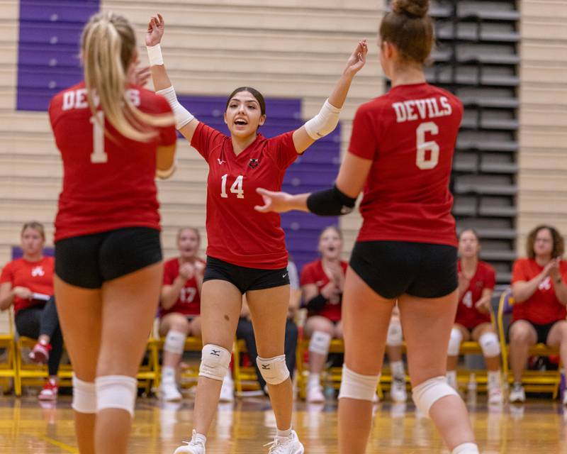 Kassy Lopez (center) celebrates the point with teammates Charlie Pellegrini (left) and Kaitlyn Coutts (right) during the match at Auxiliary Gym on September 2, 2025 at Mendota High School.