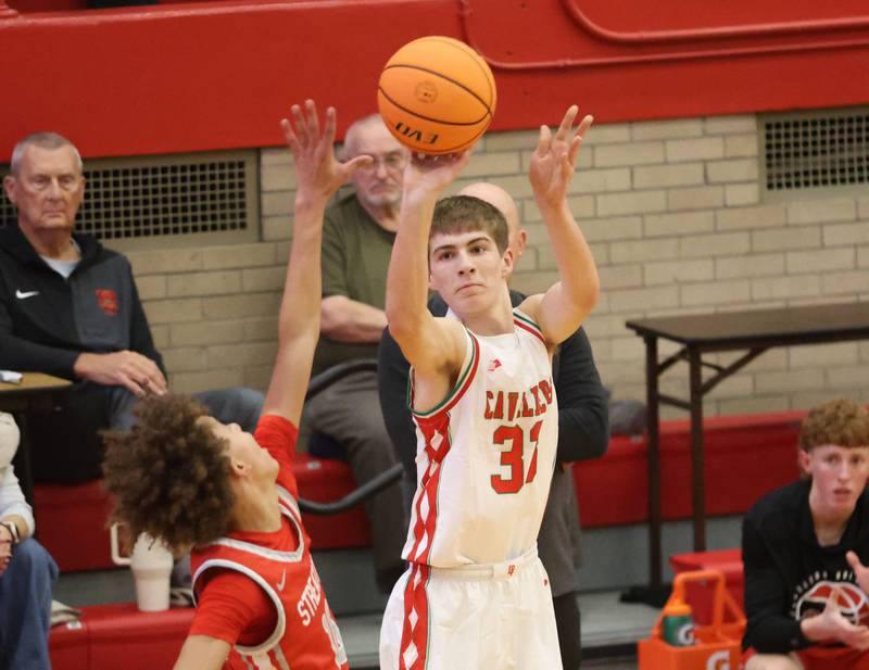 L-P's Gavin Stokes shoots a three point shot over Streator's Christian Bruton during the Dean Riley Shootin' The Rock Thanksgiving Tournament on Monday Nov. 24, 2025 in Kingman Gymnasium at Ottawa High School.