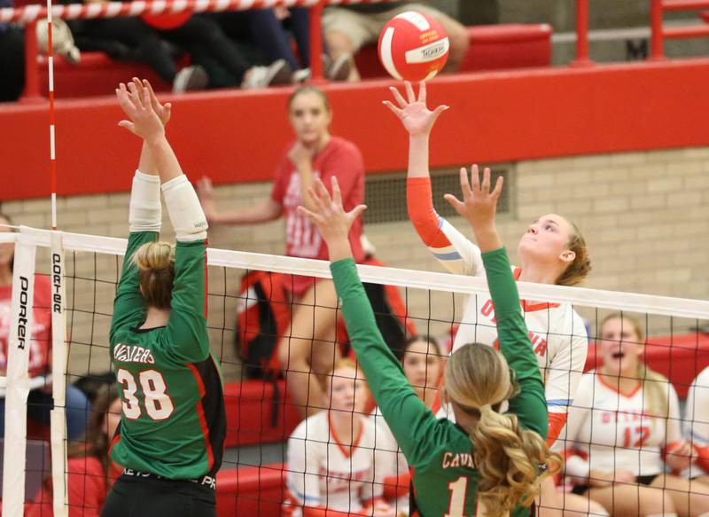 Ottawa's Isabella Markey gets the ball over the net past L-P's Aubrey Duttlinger and teammate Kelsey Frederick on Thursday, Oct. 17, 2024 in Kingman Gym at Ottawa High School.