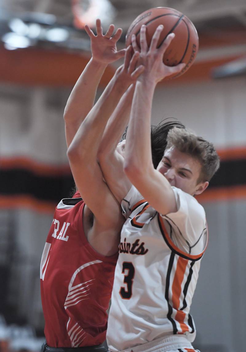 St. Charles East’s Jack Borri gets a rebound against Naperville Central’s Grady Cooperkawa in a boys basketball game in St. Charles on Wednesday, January 25, 2023.