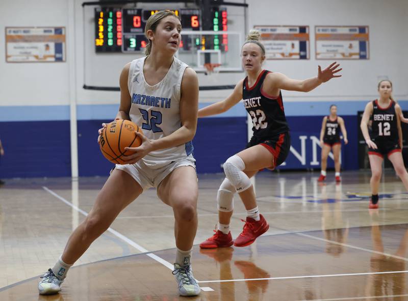Nazareth's Stella Sakalas (32) looks for an opening during a girls varsity basketball game between Benet and Nazareth academies on Saturday, Dec. 14, 2024 in La Grange Park.