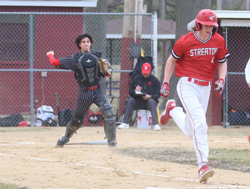 Streator's Clay Christoff runs to first base as Hall catcher Noah Plym throws the ball away on Tuesday, March 18, 2025 in Foley Field at Kirby Park in Spring Valley.