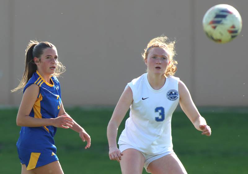 Woodstock’s Keira Bogott, right, and Johnsburg’s Charlie Eastland follow the ball in varsity soccer on Wednesday, April 23, 2025, at Johnsburg High School in Johnsburg.