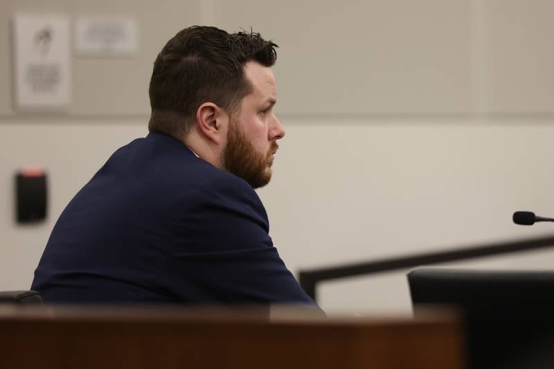 Defendant Sean Woulfe listens to closing arguments on Monday at the Will County Courthouse. Sean Woulfe, 29, is charge with reckless homicide of Lindsey Schmidt, 29, and her three sons, Owen, 6, Weston, 4, and Kaleb, 1. Monday, Mar. 28, 2022, in Joliet.