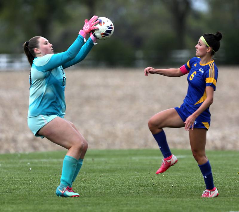 Richmond-Burton's Rylee Molczan grabs the ball as Johnsburg's Liz Smith tries to make a play during the Kishwaukee River Conference Girls Soccer Tournament Championship match on Wednesday, May 6, 2026, at Johnsburg High School.