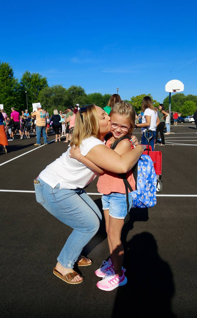 Kristin Sharp hugs daughter Hannah on her first day of third grade at Kaneland John Shields Elementary School in Sugar Grove on Wednesday, Aug. 16, 2023.