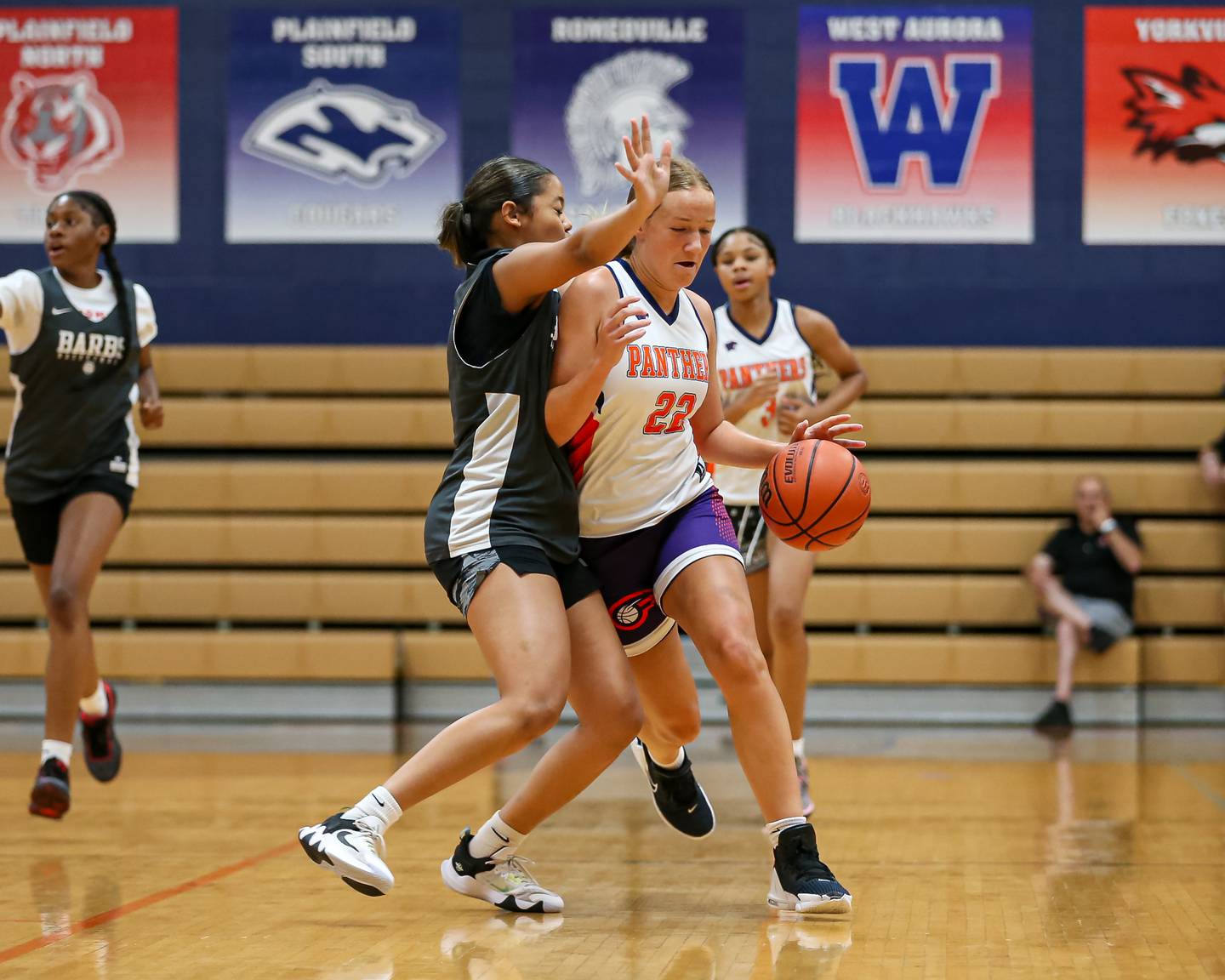 Oswego's Peyton Johnson brushes past the defense of Dekalb's Alicia Johnson at the Oswego Girls Basketball Shootout . June 30, 2023.