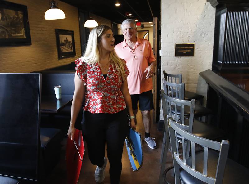 Sophia Linardos and her father, Bill, looks for places to place medieval decor on Wednesday, Sept. 11, 2024, as they prepare to open Squire on the Square restaurant in the old Public House space in the Woodstock Old Courthouse.