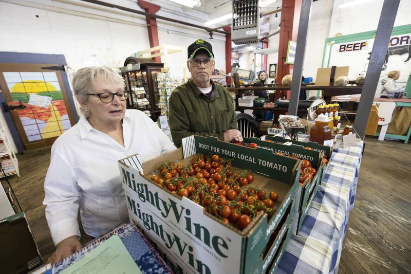 Charlin and Fred Nolan of Sterling Gardens work their booth Saturday, March 25, 2023 at Twin City Farmers Market.