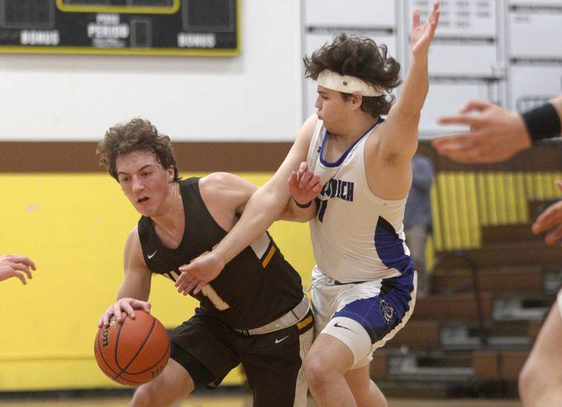 Jacobs’  Ben Jurzak, left, drives as Lake Zurich’s Jonathan Fleaka defends in Hinkle Holiday Classic boys basketball tournament game action at Jacobs High School Tuesday.