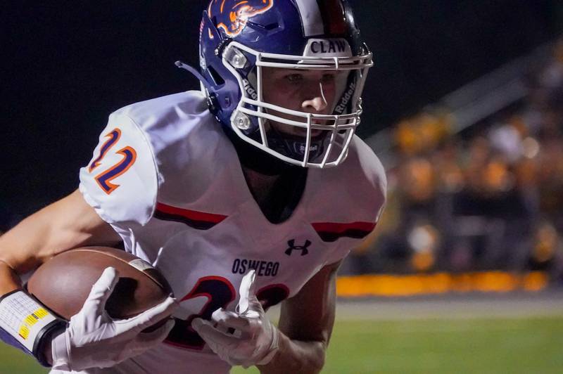Oswego’s Michael Kelly (22) runs after the catch for a touchdown against Plainfield North during a football game at Plainfield North High School on Friday, Sept. 22, 2023.
