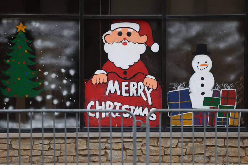 Holiday art adorns a downtown business window at the Joliet Light Up the Lights Holiday Festival on Friday, Nov. 29, 2024.