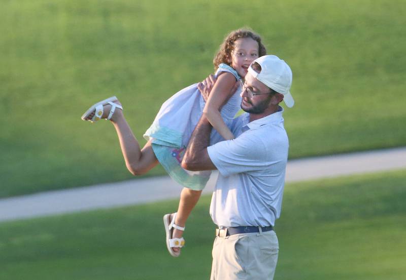 Jon Prescott hugs his daughter Madeline after winning the Illinois Valley Mens Golf Championship Tournament on Sunday, July 27, 2025 at Spring Creek Golf Course in Spring Valley.