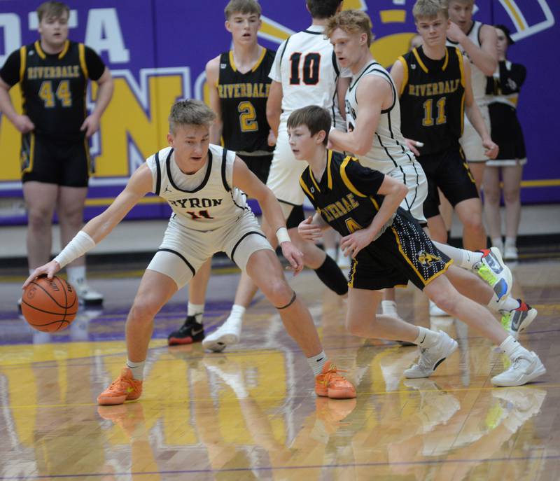 Byron's Cason Newton (11)  protects the ball from Riverdale's Paxton Kiddoo (4) during the 2A Mendota Sectional on Wednesday, Feb. 28, 2024 at Mendota High School.