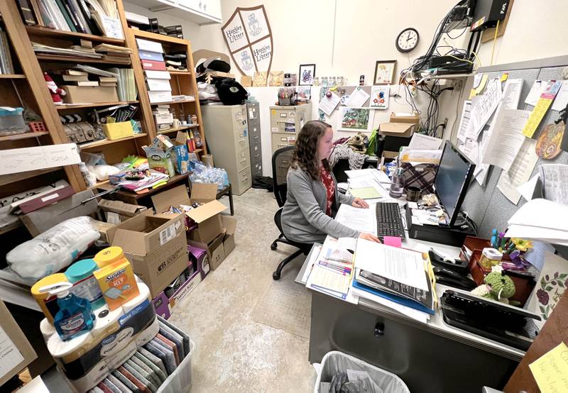 Rylie Roubal, Hinckley Public Library District director, works Thursday, April 27, 2023, in her office that has to double as a storage area due to lack of space in the current library. The hope is to renovate and move the into a larger space in a building that was donated to the library district. The renovation project has received $750,000 in federal funding and is hoping to receive another grant this year.