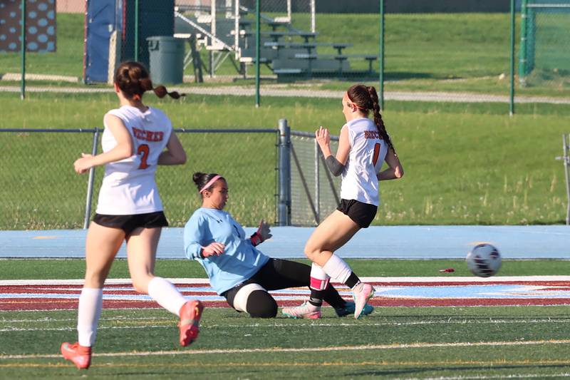 Kankakee goalkeeper Chloe Perez deflects the ball away from Beecher's Grace Durante during Kankakee's 8-4 victory over Beecher on Wednesday, April 22, 2026.