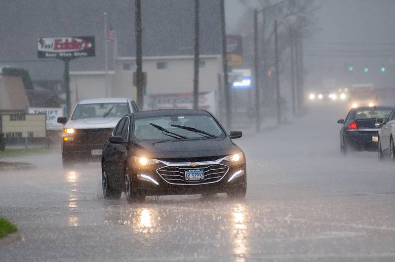 Rain floods the streets of Rock Falls Friday, April 22, 2022. The Sauk Valley was hit with a deluge of rain and high winds.