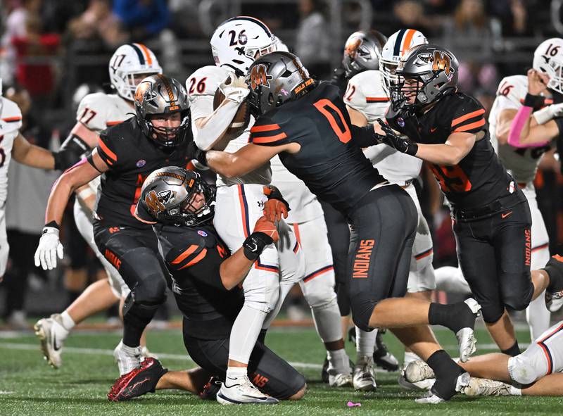 Minooka's Brady Kozlowski (0) puts a big hit on Oswego's Dekker Zelensek (26) during the conference game on Friday, OCT. 10, 2025, at Minooka.